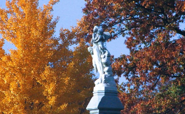 Ginko and oak leaves form a backdrop for this marble carving.