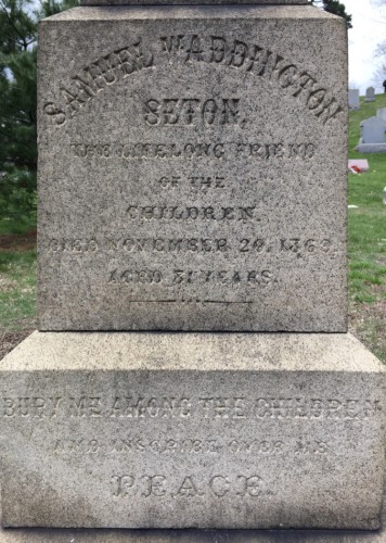 The inscription on Samuel W. Seton's obelisk notes his request to be buried with the children, has "Peace" on it, as he had requested, and was paid for by New York City's teachers.