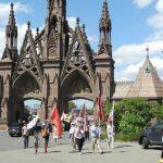 flag parade near green-wood arches