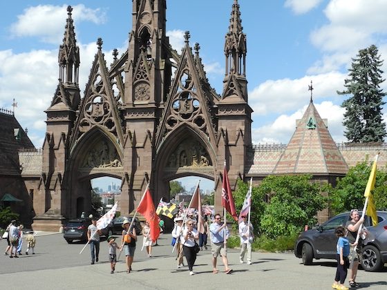 flag parade near green-wood arches