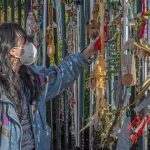 person at fence memorial installation