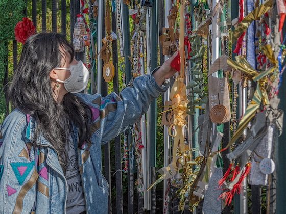 person at fence memorial installation