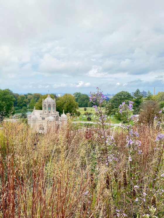 cemetery chapel with grasses and clouds